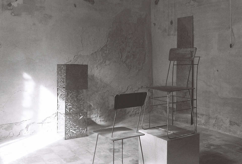 Sculpture made of metal chairs and letters by Paolo Mezzadri